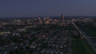 DX0002_204_045 - 5.7K aerial stock footage of the skyline while ascending over neighborhoods at twilight, Downtown Buffalo, New York