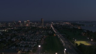 DX0002_204_051 - 5.7K aerial stock footage reverse view of I-190 leading to skyline at twilight, Downtown Buffalo, New York