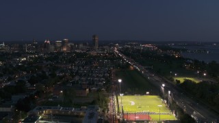 DX0002_204_053 - 5.7K aerial stock footage ascend near soccer field and I-190 for view of skyline at twilight, Downtown Buffalo, New York