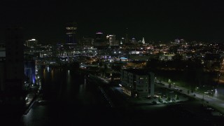 DX0002_205_009 - 5.7K aerial stock footage of following Buffalo River toward the skyline at night, Downtown Buffalo, New York