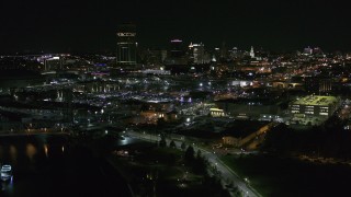 DX0002_205_012 - 5.7K aerial stock footage of the skyline while descending by river at night, Downtown Buffalo, New York