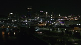DX0002_205_013 - 5.7K aerial stock footage approach the skyline from river and parking lots at night, Downtown Buffalo, New York