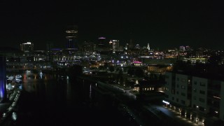 DX0002_205_018 - 5.7K aerial stock footage of flying past grain elevator to reveal the downtown skyline at night, Downtown Buffalo, New York