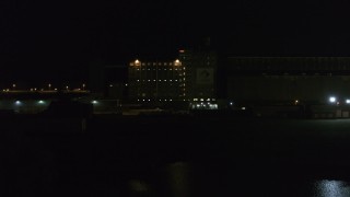 DX0002_205_019 - 5.7K aerial stock footage slowly approach and orbit flour mill at night, Buffalo, New York