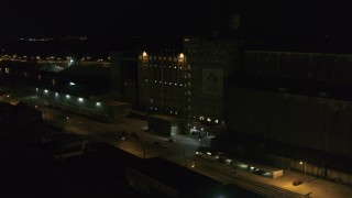 DX0002_205_021 - 5.7K aerial stock footage orbit a flour mill at night, Buffalo, New York