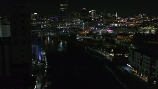 DX0002_205_024 - 5.7K aerial stock footage of flying over the river toward the downtown skyline at night, Downtown Buffalo, New York