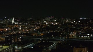 DX0002_205_037 - 5.7K aerial stock footage of a wide view of distant Buffalo General Medical Center at night, Downtown Buffalo, New York