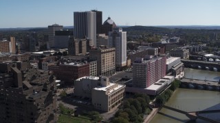 DX0002_206_002 - 5.7K aerial stock footage ascend away from riverfront hotels and the city's skyline, Downtown Rochester, New York