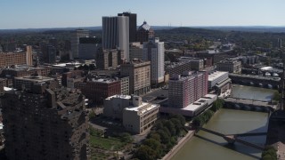 DX0002_206_003 - 5.7K aerial stock footage a stationary view of riverfront hotels and the city's skyline, Downtown Rochester, New York