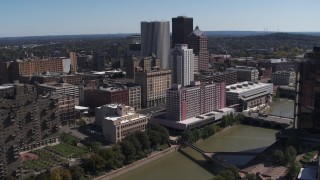 DX0002_206_004 - 5.7K aerial stock footage orbiting riverfront hotels and the city's skyline, Downtown Rochester, New York