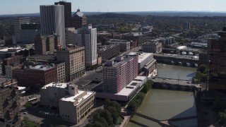 DX0002_206_007 - 5.7K aerial stock footage reverse view of riverfront hotel and city's skyline, Downtown Rochester, New York