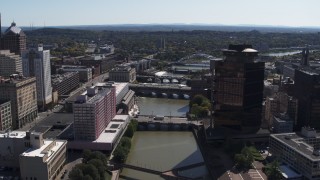DX0002_206_008 - 5.7K aerial stock footage reverse view of riverfront hotel across from office building, Downtown Rochester, New York