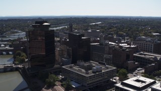DX0002_206_015 - 5.7K aerial stock footage orbit office buildings and hotel by the Genessee River, Downtown Rochester, New York