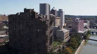 DX0002_206_024 - 5.7K aerial stock footage orbit riverfront apartment complex and reveal river, Downtown Rochester, New York