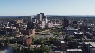 DX0002_207_006 - 5.7K aerial stock footage reverse view of river bridges and skyline, reveal the waterfall, Downtown Rochester, New York