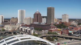 DX0002_207_024 - 5.7K aerial stock footage reverse view of the skyline and reveal Douglass-Anthony Bridge, Downtown Rochester, New York