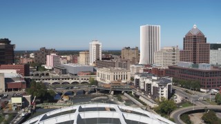 DX0002_207_027 - 5.7K aerial stock footage of bridges spanning Genesee River and The Metropolitan skyscraper, Downtown Rochester, New York