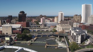 DX0002_207_033 - 5.7K aerial stock footage of passing bridges over the river and city buildings, Downtown Rochester, New York