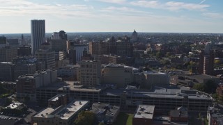 DX0002_208_015 - 5.7K aerial stock footage descend and flyby office buildings and parking garage, Downtown Rochester, New York