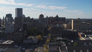 DX0002_208_019 - 5.7K aerial stock footage flying by office buildings and parking garage by East Avenue, Downtown Rochester, New York