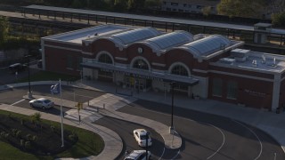 DX0002_209_023 - 5.7K aerial stock footage orbiting a brick train station at sunset in Downtown Rochester, New York