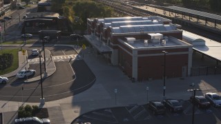 DX0002_209_025 - 5.7K aerial stock footage of circling a brick train station at sunset in Downtown Rochester, New York
