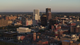 DX0002_209_028 - 5.7K aerial stock footage of flying away from First Federal Plaza and office buildings at sunset, Downtown Rochester, New York