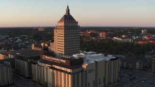 DX0002_209_036 - 5.7K aerial stock footage fly away from college and Kodak Tower at sunset, Rochester, New York