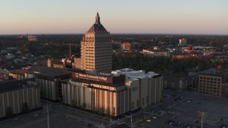 DX0002_209_037 - 5.7K aerial stock footage of orbiting a college and Kodak Tower at sunset, Rochester, New York