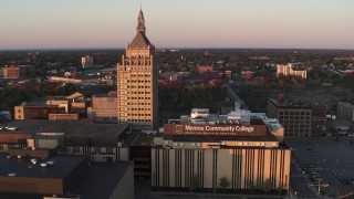DX0002_209_038 - 5.7K aerial stock footage of a reverse view of a college and Kodak Tower at sunset, Rochester, New York