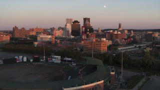 DX0002_209_044 - 5.7K aerial stock footage reverse view of First Federal Plaza and radio tower at sunset, reveal stadium, Downtown Rochester, New York
