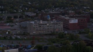 DX0002_210_004 - 5.7K aerial stock footage of orbiting a brick factory building and water tower at twilight, Downtown Rochester, New York