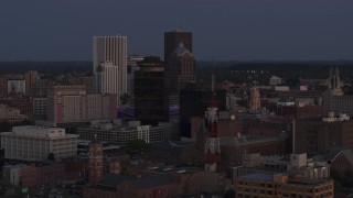 DX0002_210_008 - 5.7K aerial stock footage descend and focus on Legacy Tower at twilight while passing radio tower, Downtown Rochester, New York