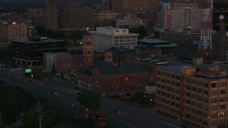 DX0002_210_012 - 5.7K aerial stock footage of orbiting Spiritus Christi Church at twilight, Downtown Rochester, New York