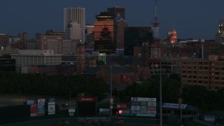 DX0002_210_014 - 5.7K aerial stock footage of reverse view of Spiritus Christi Church at twilight, Downtown Rochester, New York