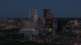 DX0002_210_019 - 5.7K aerial stock footage of flying by the city skyline behind First Federal Plaza at twilight, Downtown Rochester, New York