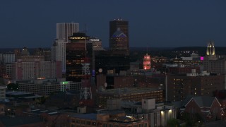 DX0002_210_020 - 5.7K aerial stock footage of flying by the First Federal Plaza, The Powers Building at twilight, Downtown Rochester, New York