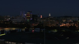 DX0002_210_027 - 5.7K aerial stock footage of office buildings seen from baseball stadium at night, Downtown Rochester, New York