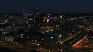 DX0002_210_028 - 5.7K aerial stock footage ascend and orbit office buildings at night, Downtown Rochester, New York