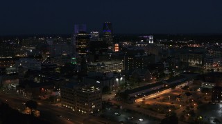DX0002_210_033 - 5.7K aerial stock footage ascend while focused on office buildings and skyline at night, Downtown Rochester, New York