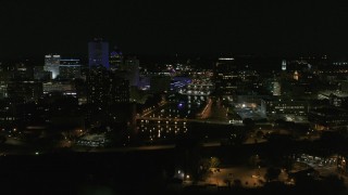DX0002_210_038 - 5.7K aerial stock footage of the Genesee River and skyline seen during ascent at night, Downtown Rochester, New York