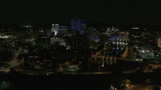 DX0002_210_039 - 5.7K aerial stock footage stationary view of the Genesee River and skyline at night, Downtown Rochester, New York