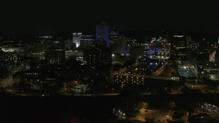 DX0002_210_040 - 5.7K aerial stock footage of flying by the Genesee River and skyline at night, Downtown Rochester, New York