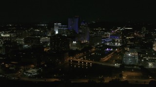 DX0002_210_043 - 5.7K aerial stock footage of approaching the city's skyline beside the Genesee River at night, Downtown Rochester, New York