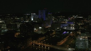 DX0002_210_044 - 5.7K aerial stock footage of orbiting the city's skyline beside the Genesee River at night, Downtown Rochester, New York