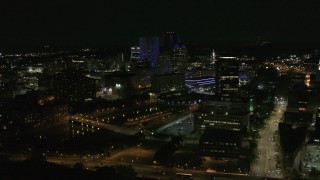 DX0002_210_045 - 5.7K aerial stock footage fly away from and orbit city's skyline beside the Genesee River at night, Downtown Rochester, New York