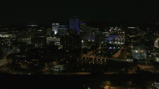 DX0002_210_046 - 5.7K aerial stock footage of a wide orbit of city's skyline beside the Genesee River at night, Downtown Rochester, New York