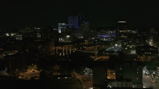 DX0002_210_050 - 5.7K aerial stock footage of flying by the Genesee River and skyline at night, Downtown Rochester, New York