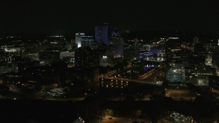DX0002_210_051 - 5.7K aerial stock footage of a reverse view of the Genesee River and skyline at night, Downtown Rochester, New York