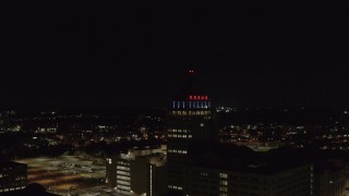 DX0002_210_053 - 5.7K aerial stock footage of orbiting Kodak Tower at night, Rochester, New York
